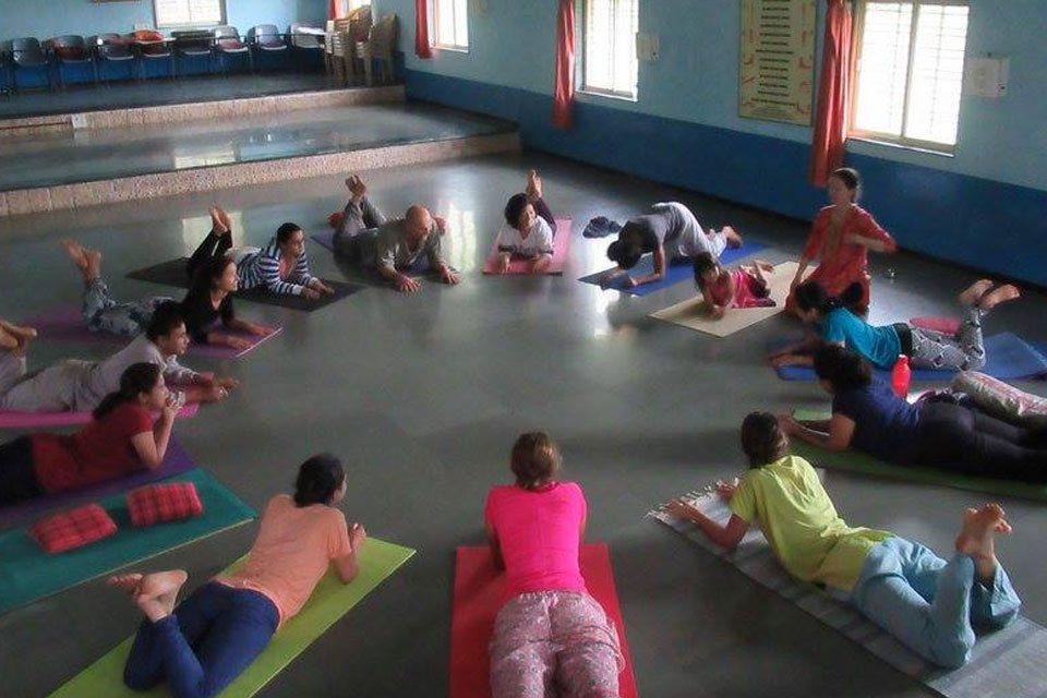 TTC students at Yoga Vidya Dham Practising Yoga